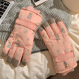 Detailed view of pink winter gloves with bear patterns and gray non-slip finger pads
