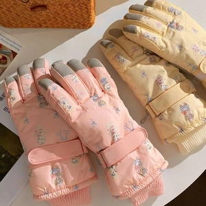 Detail of winter ski gloves with bear print, non-slip fingertips and adjustable wrist straps