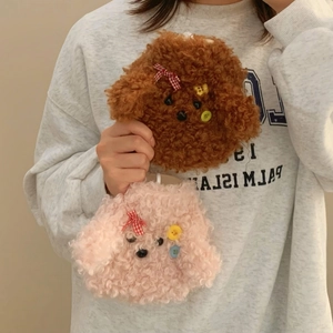 Close-up of cute plush dog hand warmer in brown and pink lamb wool with bow detail