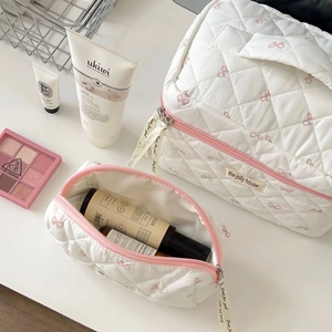 Quilted white cosmetic bags with pink bow embroidery and handles for travel storage