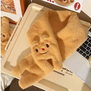 Detail of warm yellow plush scarf with cute cartoon bear embroidery and 3D ears