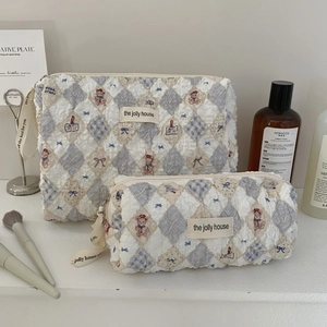 Detailed set of blue and white quilted bear cosmetic bags in large and small sizes