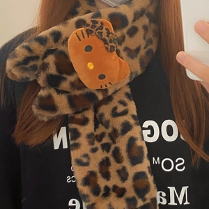 Detail of plush leopard print scarf with cute cartoon character and soft faux fur texture