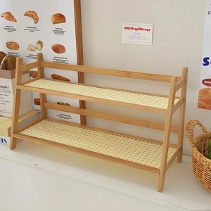 Detail view of double-layer wooden desk shelf with cream rattan mesh and warm aesthetic