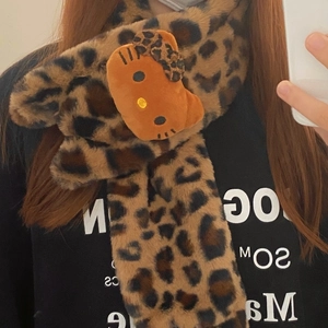 Detail of plush leopard print scarf featuring a cute cartoon kitty plush ornament