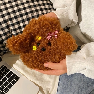 Close-up of cute plush dog hot water bottle with brown curly fur and bow tie detail