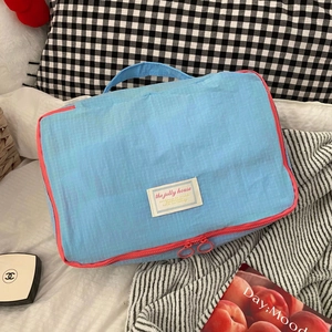Waterproof nylon travel organizer bag with blue grid pattern and pink zipper
