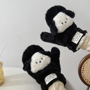 Détail de gants en peluche chiot avec fausse fourrure douce et étiquette tissée décorative