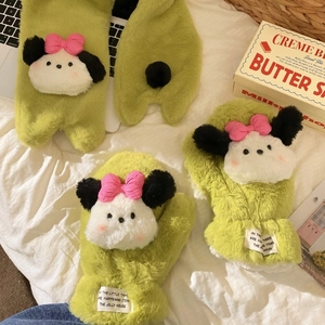 Detail of plush green winter scarf and mittens featuring a cute cartoon puppy design