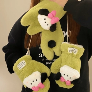 Detail of plush green puppy mittens with soft faux fur texture and cute pink bow decor