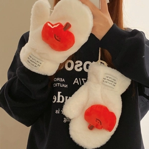 Detail of white plush mittens with a smiling red apple patch and soft hanging neck cord