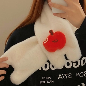 Detail of plush white scarf featuring a cute red apple embroidery with a smiley face