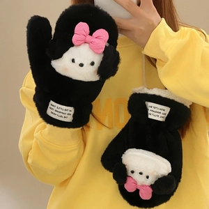 Detail of plush black and white mittens with pink bow and cartoon puppy design