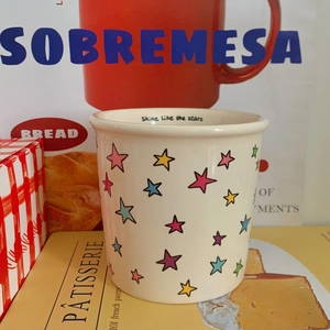 Detail of ceramic mug showing stars and Shine Like The Stars text inside the rim