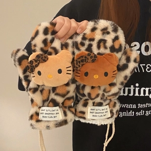 Close-up of brown leopard print plush gloves with cute cartoon character embellishment