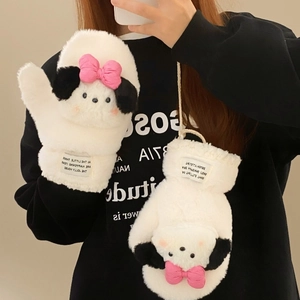 Close-up of white plush puppy mittens with pink bow and warm neck string for winter