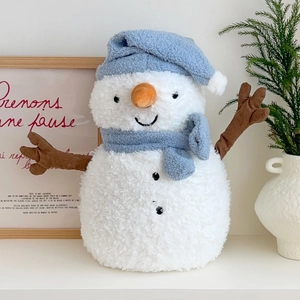 Cute snowman plush hot water bottle with blue hat and scarf on a clean white desk