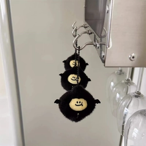 Cute black plush devil lemon keychain with yellow face and wings on metal chain