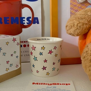 Detailed view of ceramic star mug with 'Shine like the stars' text and gift box