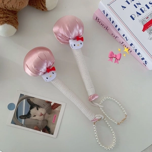 Close-up of pink satin massage hammers with Hello Kitty heads and pearl handles