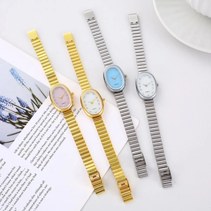 Detail of four oval quartz watches with diamond markers and stylish metal bands
