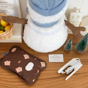 Detail of cute snowman hot water bottle plush cover with charging clip and bear pattern