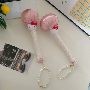 Detail of pink satin Hello Kitty massage hammers with white cotton rope handles