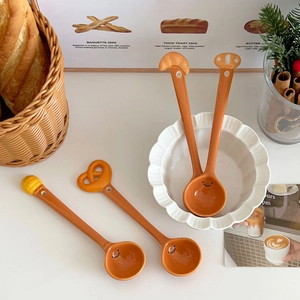 Creative bread-themed ceramic spoon set with cute smiling face and croissant handle design