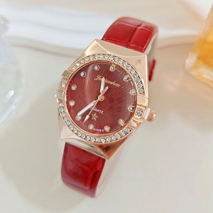 Detail of red sunray dial with star accents and sparkling rhinestones on the bezel
