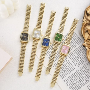Detailed shot of retro square gold-tone quartz watches in five vibrant dial colors
