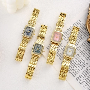 Detail of luxury rectangular gold quartz watches with diamond bezel and marble dials