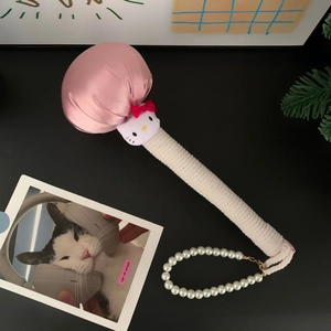 Detail of pink satin massage hammer with plush cat head and pearl chain handle