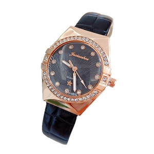 Detailed side view of rose gold rhinestone bezel and black leather strap watch