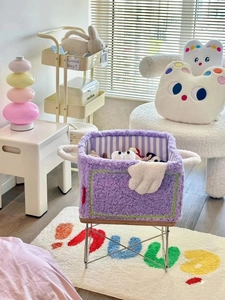 Close-up of purple faux lamb wool storage basket with white handles and striped lining