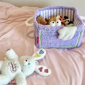 Close-up of purple plush storage basket with white rabbit doll and soft faux fur texture