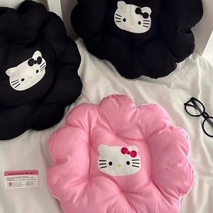 Close-up of flower-shaped plush cushions with cartoon cat prints in black and pink
