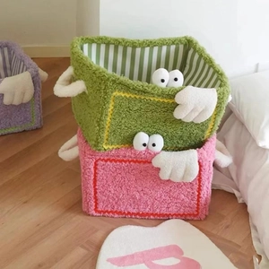 Detail of plush cartoon storage baskets showing soft teddy fleece texture and stripe lining