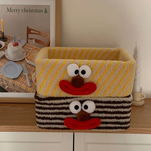 Detail of plush clown storage baskets with striped textures and cute cartoon faces