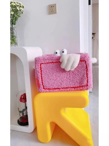 Close-up of cute pink plush teddy fleece storage basket with cartoon eye details