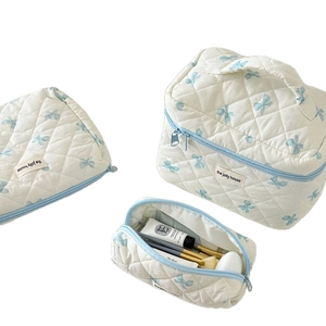 Quilted 3-piece makeup bag set with blue bow pattern and top handle storage case