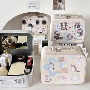 Detail of cream cosmetic case with cute animal prints, handle, and built-in mirror
