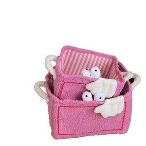 Set of two pink fleece storage baskets with cute doll faces and striped lining