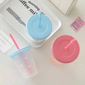 Three Korean-style aesthetic cold drink cups with pastel lids and bow patterns