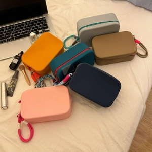 Waterproof silicone cosmetic bags in various colors with contrasting braided wrist straps
