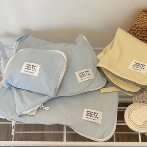 Travel luggage organizer set in light blue and yellow nylon with zipper closure