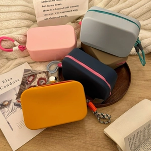 Group of colorful waterproof silicone cosmetic bags on a cozy knitted blanket
