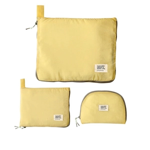 Minimalist bright yellow travel organizer set with three waterproof storage bags