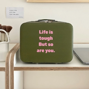 Detail of a large capacity olive green makeup box with pink text and black handles