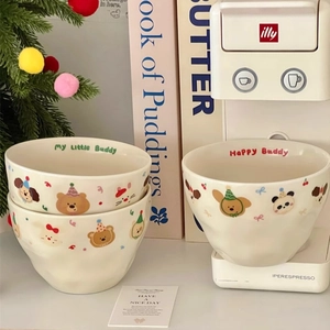 Detailed view of handmade ceramic bowls with cute cartoon animals and wave texture