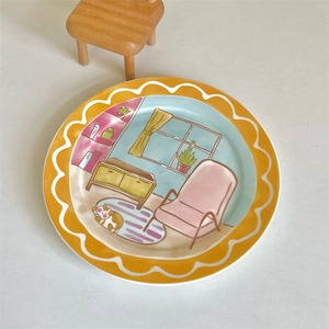 Detail view of round ceramic plate featuring hand-painted cartoon living room illustration